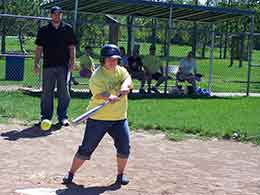 player in yellow shirt batting